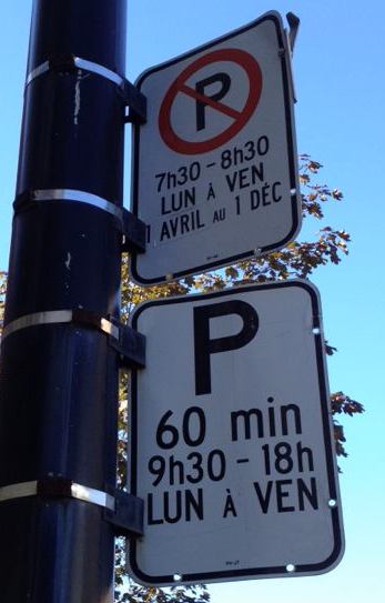 Monolingual parking restrictions sign